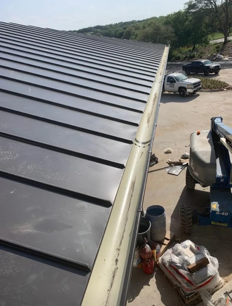 Standing seam panel and gutter detail on a metal roofing jobsite in Chocolay